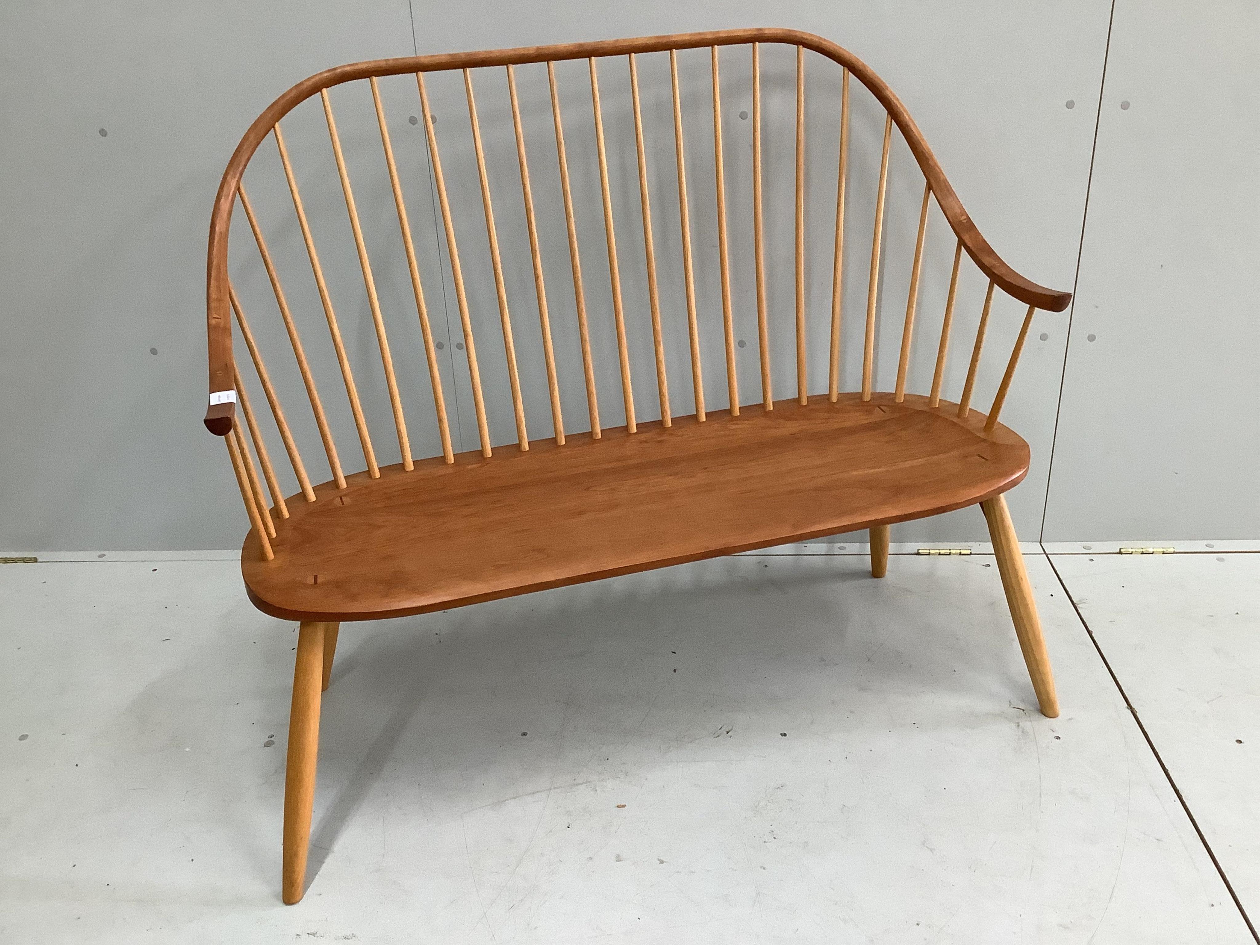 A Thomas Moser cherrywood 'continuous arm’ bench, width 122cm, depth 50cm, height 106cm. Condition - good